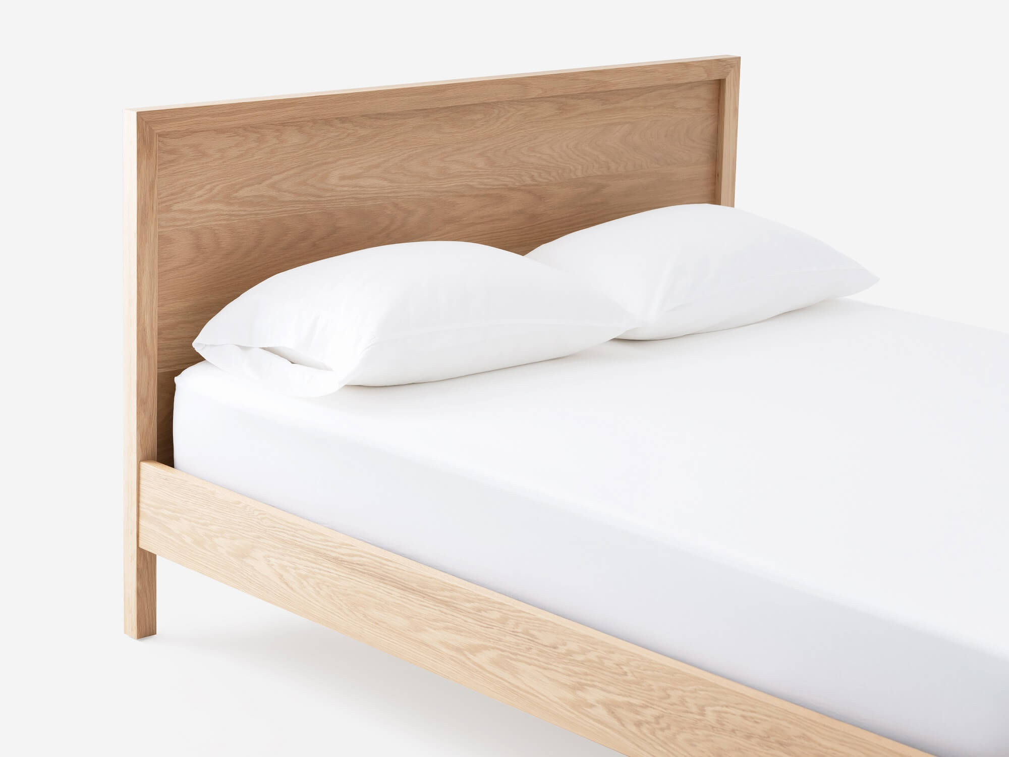 Close up view of the EQ3 Marcel platform bed frame headboard in oak